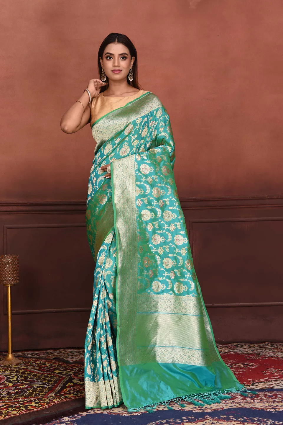Teal saree with ornate gold motifs